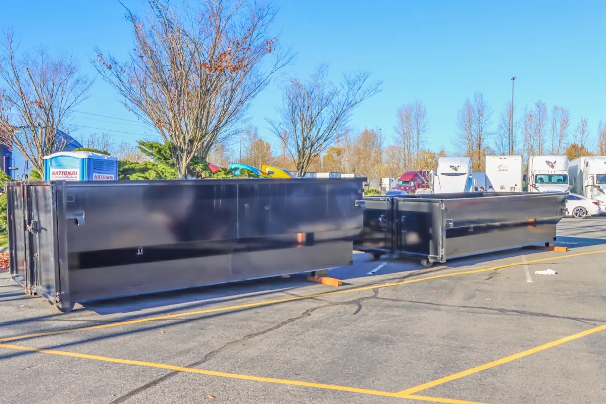 Professional dumpster rental service with roll-off container on residential driveway in Yoakum